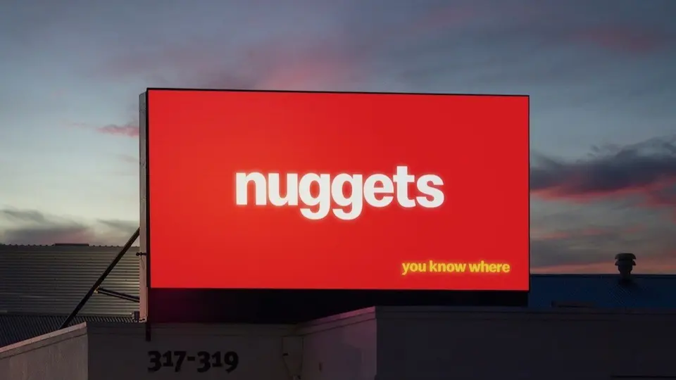 Red billboard reading “nuggets — you know where”, with no logo
